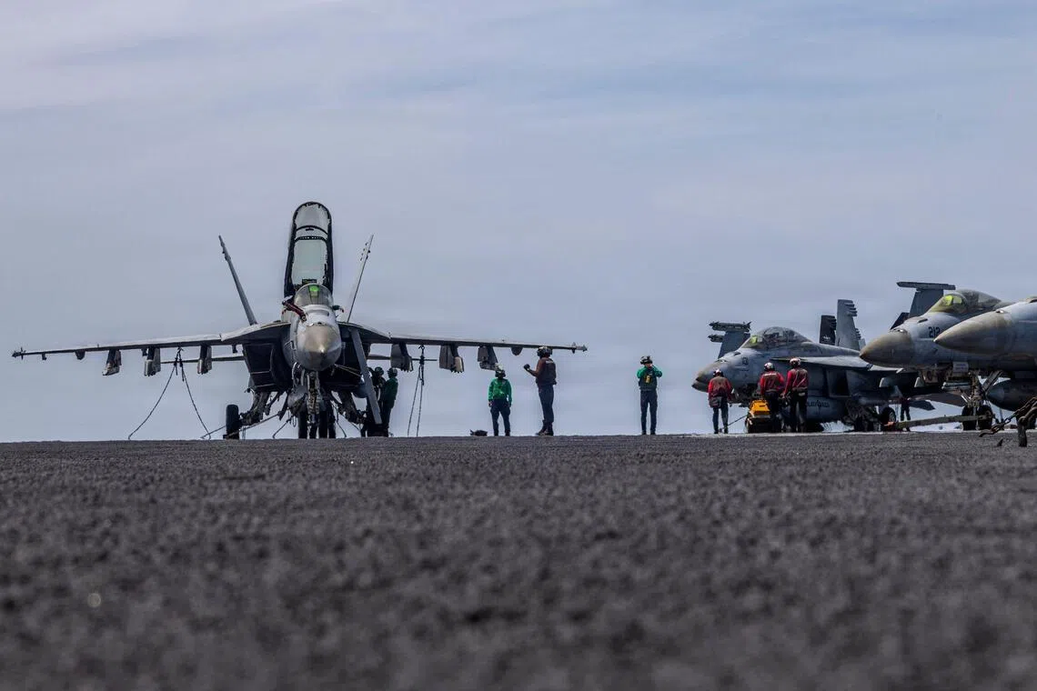 A US Navy handout photo released on May 4 shows US sailors conducting maintenance on the flight deck of the USS Abraham Lincoln in April 2026. 