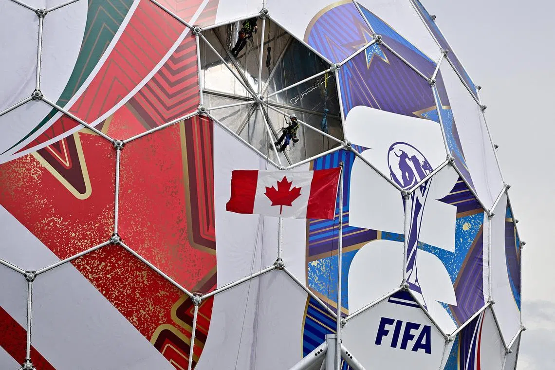 Workers prepare to install the final panel on the dome at Science World in Vancouver, Canada, on June 3, 2026. The installation will complete its transformation into a 40-metre-diameter replica of a football ahead of the FIFA World Cup.