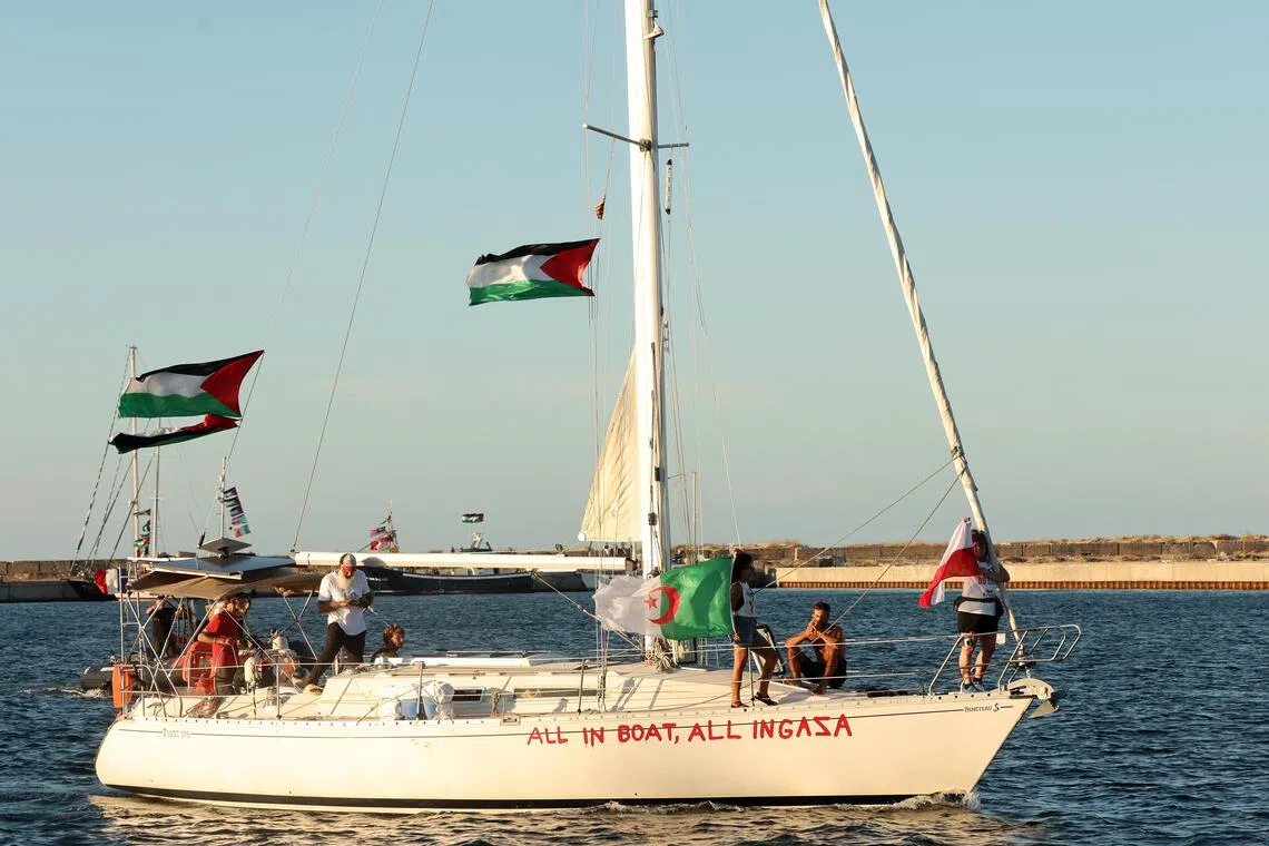 Flags fly aboard a boat of the Global Sumud Flotilla (GSF) before its departure from the port of Bizerte, northern Tunisia, on Sept 13, 2025.