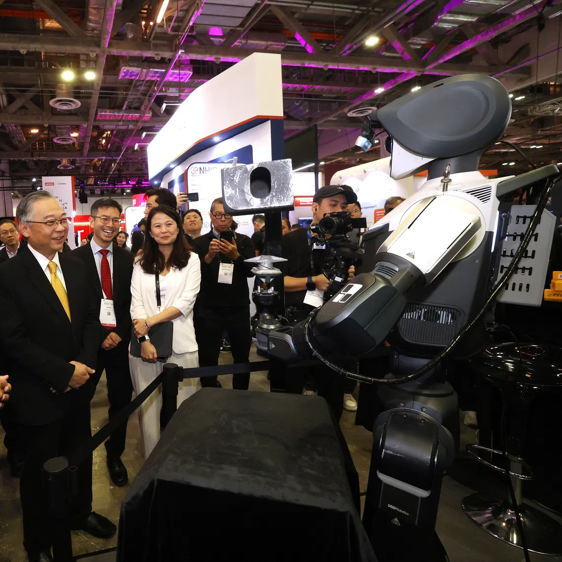 Deputy Prime Minister Gan Kim Yong viewing a humanoid robot under development at the Singapore Week of Innovation and Technology on Oct 27. Among the new initiatives is the Champions of AI programme to help ambitious Singapore-based companies committed to making AI a core driver of growth.