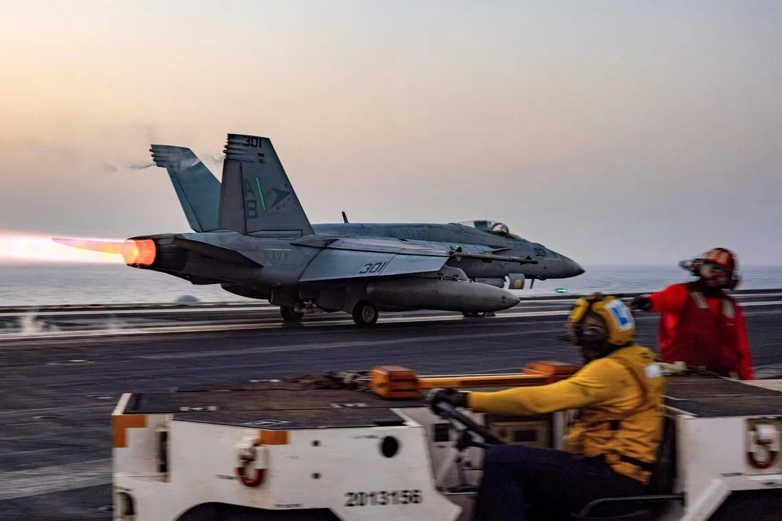 A US F/A-18 Super Hornet attack fighter jet taking off from the US Navy's USS Harry S. Truman aircraft carrier, in March 2025.