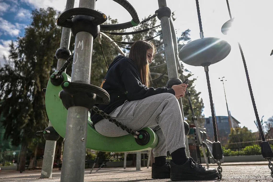 Katerina Daniil, 14, looks at social media posts, as Greece is set to ban under-15s from social media in European crackdown, in Athens, Greece, February 26, 2026. REUTERS/Louisa Gouliamaki