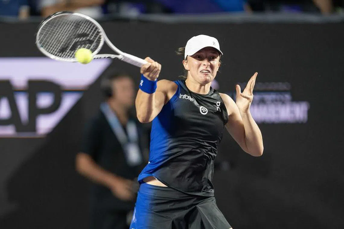 Nov 1, 2023; Cancun, Mexico; Iga Swiatek (POL) returns a shot during her match against Coco Gauff (USA) on day four of the GNP Saguaros WTA Finals Cancun. Mandatory Credit: Susan Mullane-USA TODAY Sports