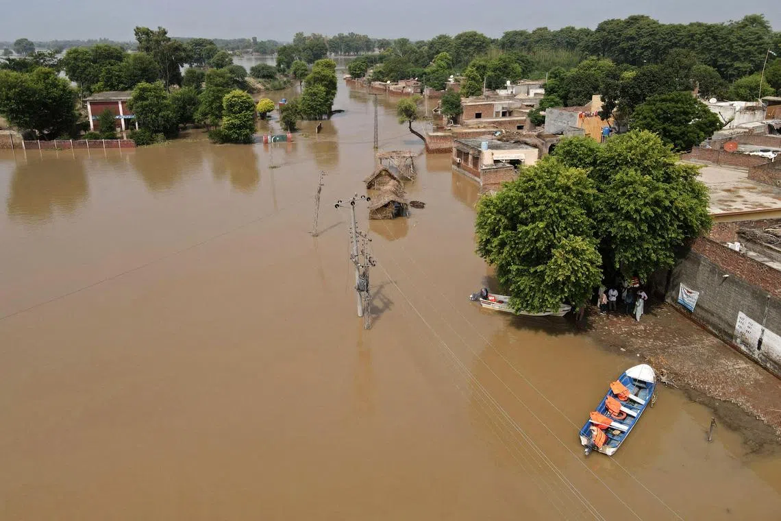 TOPSHOT - This photograph shows an aerial view of the flooded Chanda Singh Wala village in Kasur district on August 22, 2023. (Photo by Arif ALI / AFP)