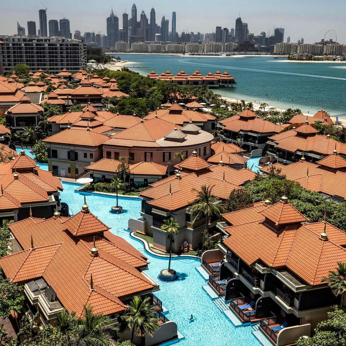 The Anantara The Palm Dubai Resort is pictured near the Dubai Marina (background) in Dubai on June 6. 