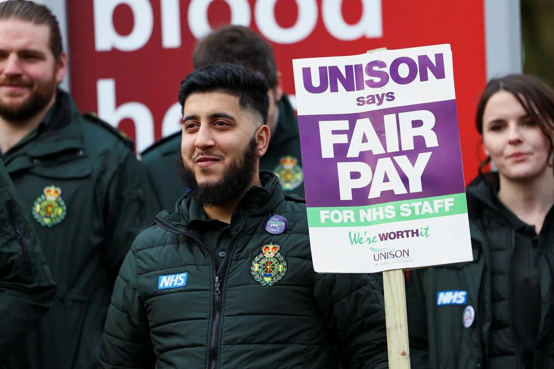 Ambulance workers take part in a strike, in Manchester, Britain, on Jan 11, 2023.