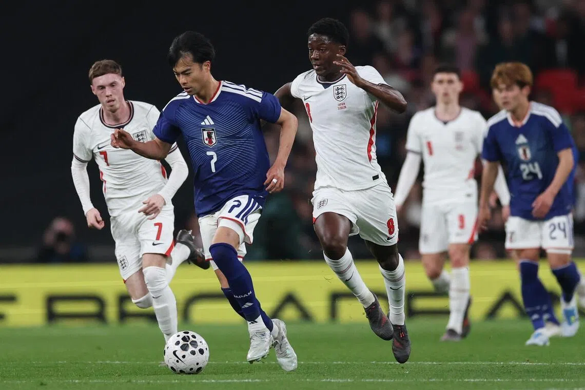 Kaoru Mitoma trying to evade the attentions of England's Kobbie Mainoo (right) and Cole Palmer during the 1-0 friendly win over England at Wembley on March 31, 2026, in London.