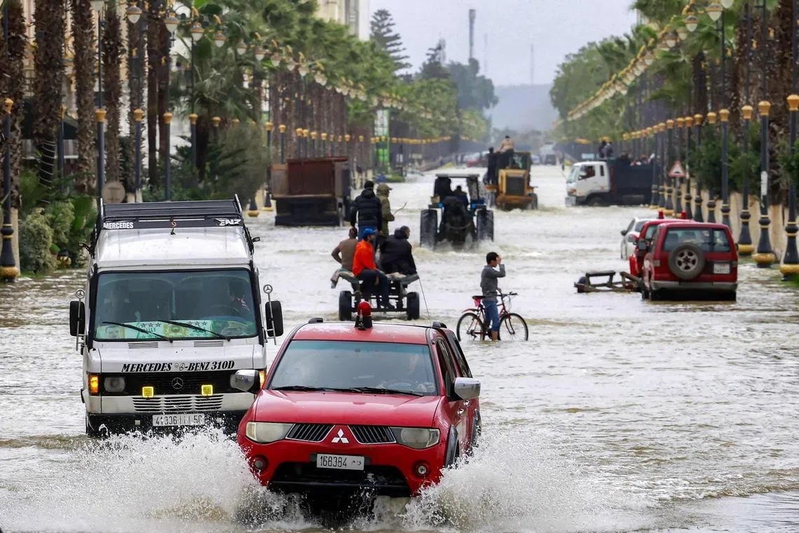 Vehicles move along an inundated main street in Morocco's north-western city of Ksar el-Kebir on Jan 29.