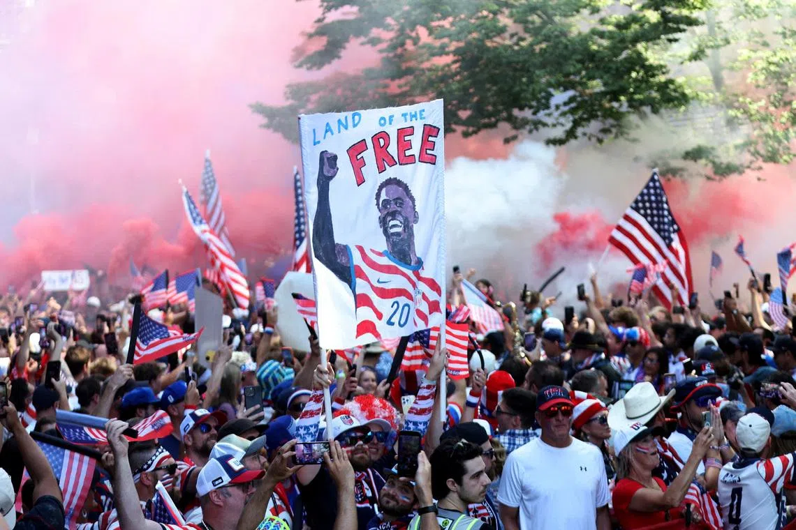 United States fans gather before the match with a Folarin Balogun banner in Seattle on July 6.