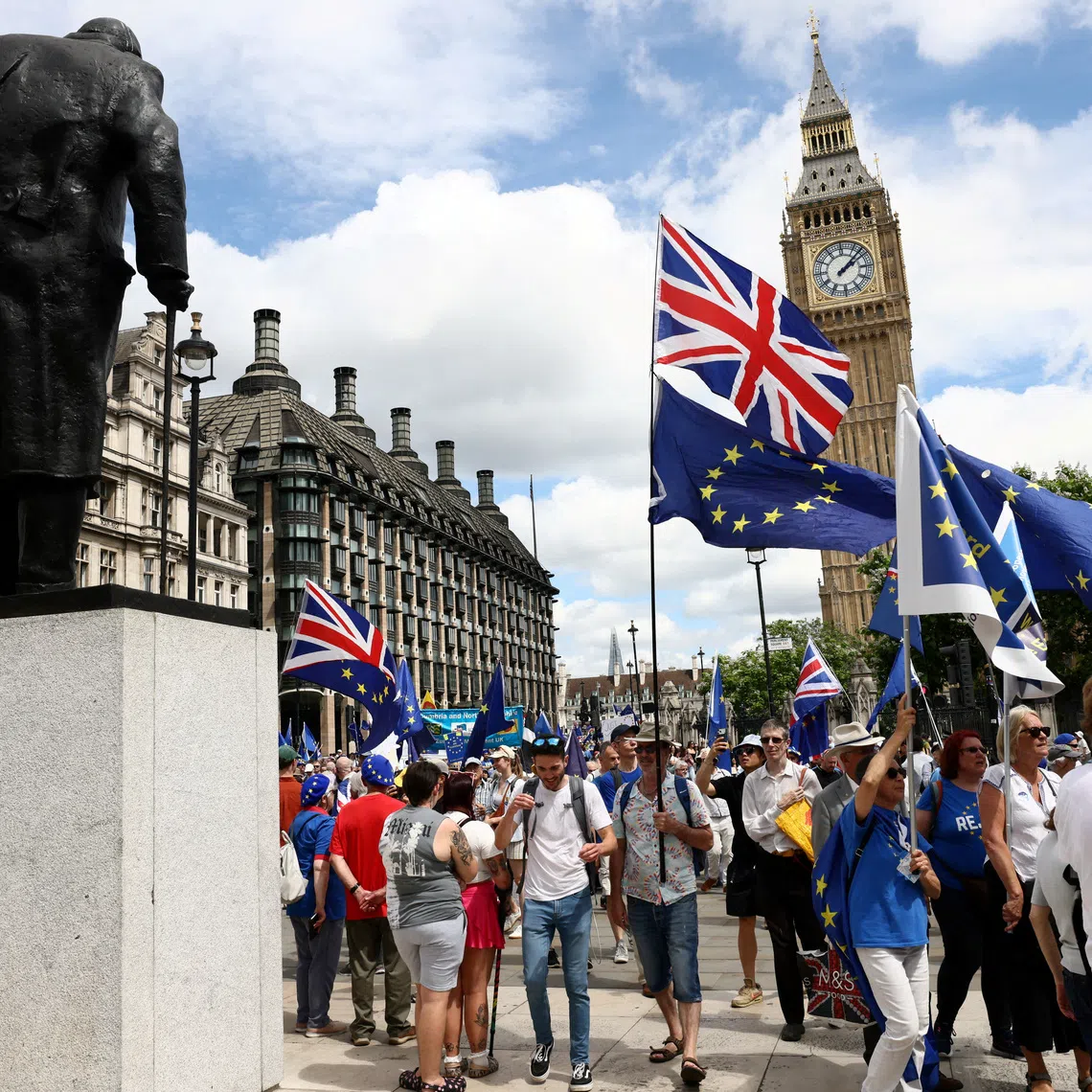 FILE PHOTO: People walk past the Elizabeth Tower, commonly known as Big Ben, during the National Rejoin March IV organised by National Rejoin March (NRM), marking ten years since Britain voted to leave the European Union in 2016 and calling for closer cooperation between Britain and Europe, in London, Britain, June 20, 2026. REUTERS/Jack Taylor/File Photo