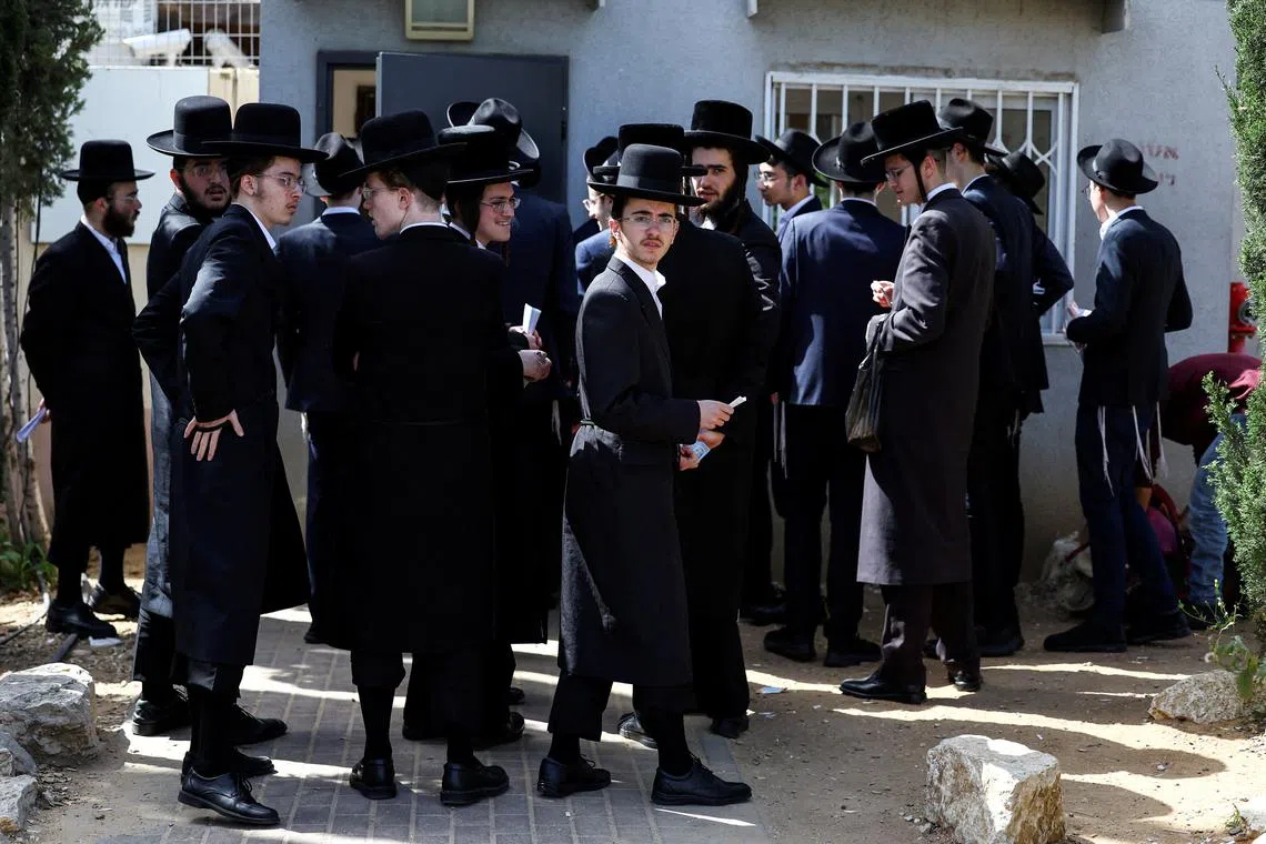 FILE PHOTO: Ultra-Orthodox Jews line up at an Israeli draft office to process their exemptions from mandatory military service at a recruitment base in Kiryat Ono, Israel March 28, 2024. REUTERS/Hannah McKay/File Photo