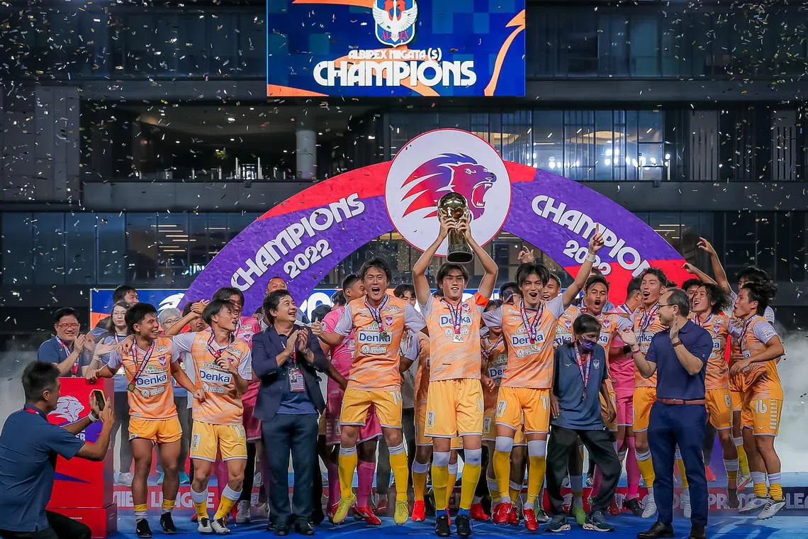 Albirex Niigata’s captain Jun Kobayashi (4) and his team lifting the trophy after their match against Geylang International in the Singapore Premier League match at Tampines Stadium, 21 Oct 2022.