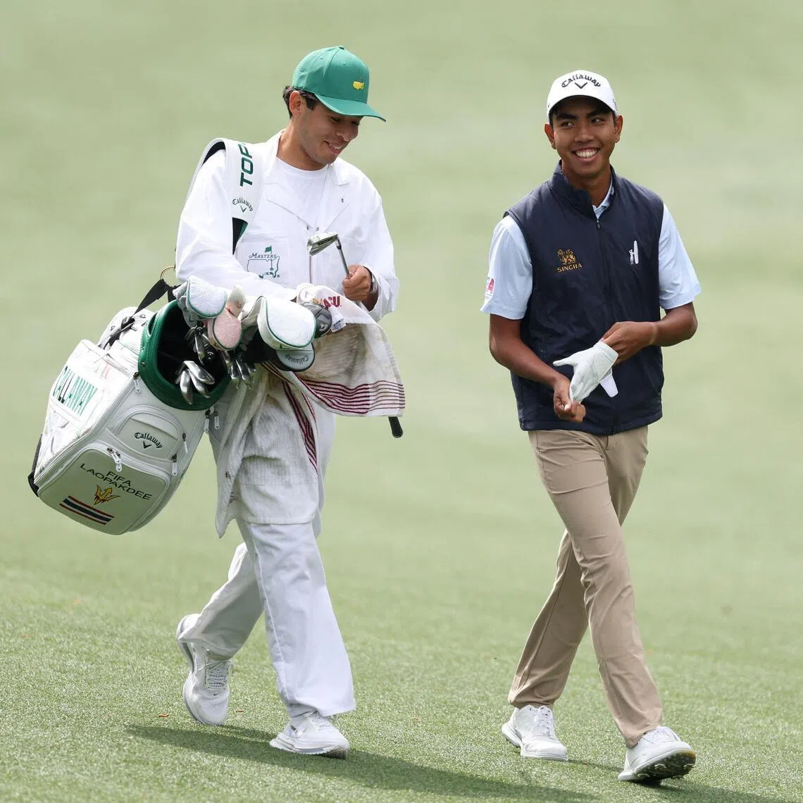 Thailand's Fifa Laopakdee and his caddie Santiago Botero walk the 13th hole at Augusta National Golf Club on April 6, during a practice round prior to the 2026 Masters Tournament.