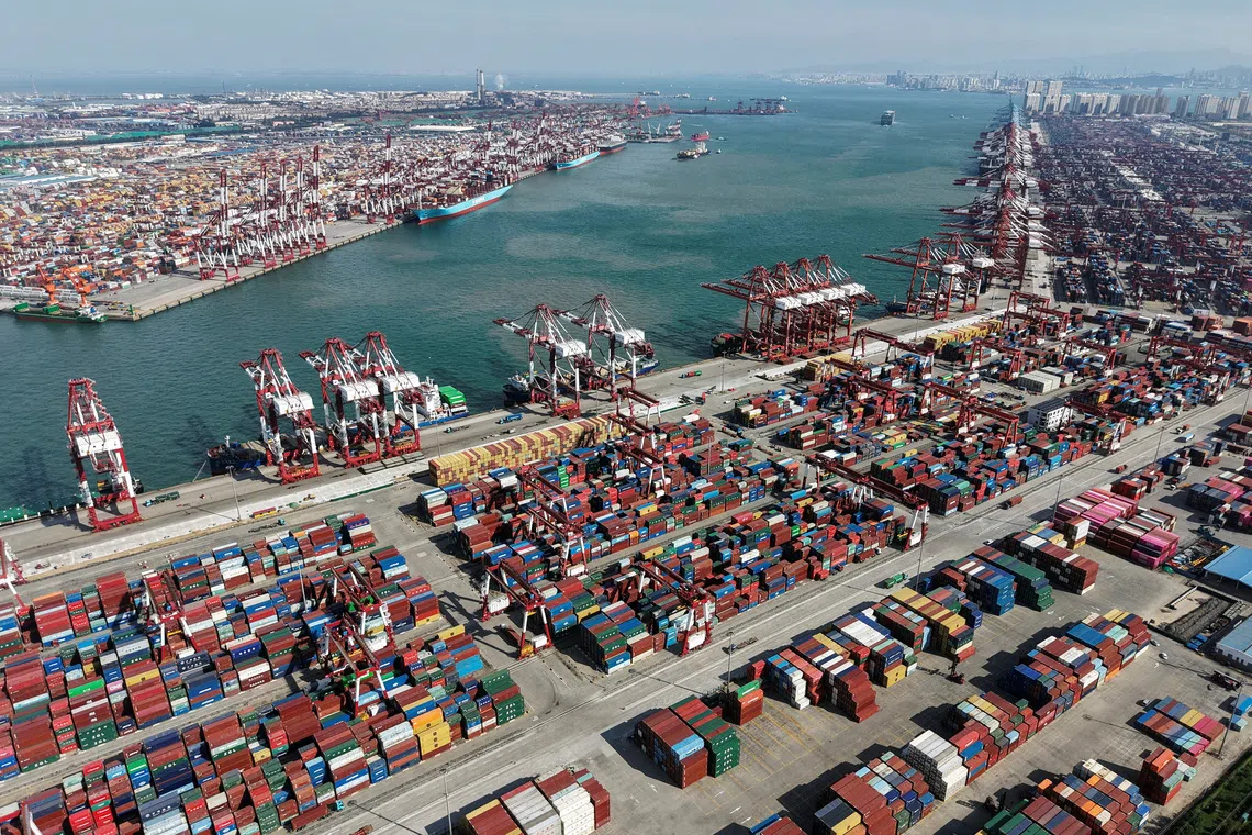 A drone view shows ships and containers at the port in Qingdao, Shandong province, China October 20, 2025. China Daily via REUTERS