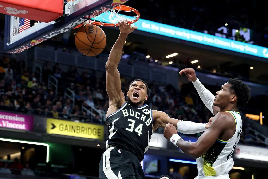 Giannis Antetokounmpo of the Milwaukee Bucks dunks the ball while defended by Bennedict Mathurin of the Indiana Pacers at Gainbridge Fieldhouse.
