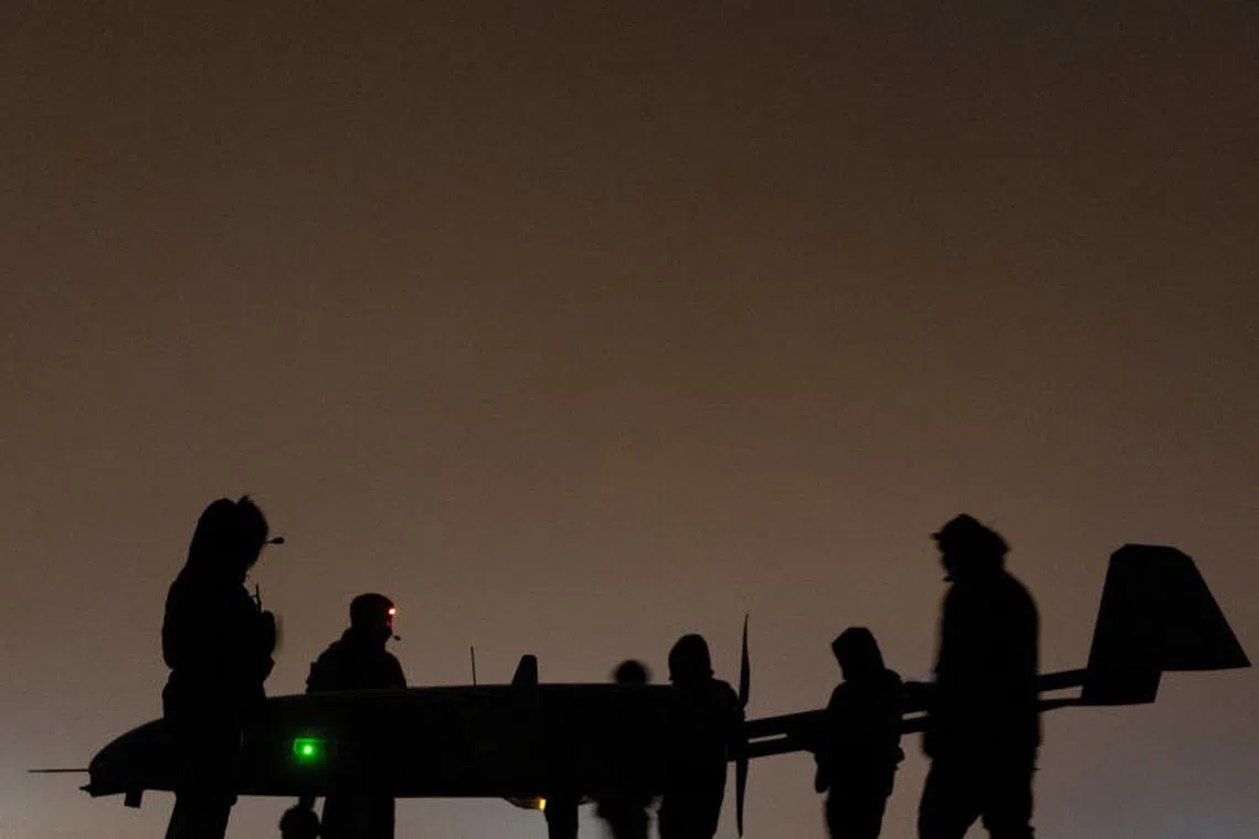 FILE PHOTO: Ukrainian service members of the 14th Unmanned Aerial Systems Regiment stand next to a deep strike unmanned aerial vehicle before its launch toward Russian territory, amid Russia's attack on Ukraine, in an undisclosed location in Ukraine, undisclosed date, 2025. REUTERS/Valentyn Ogirenko/File Photo