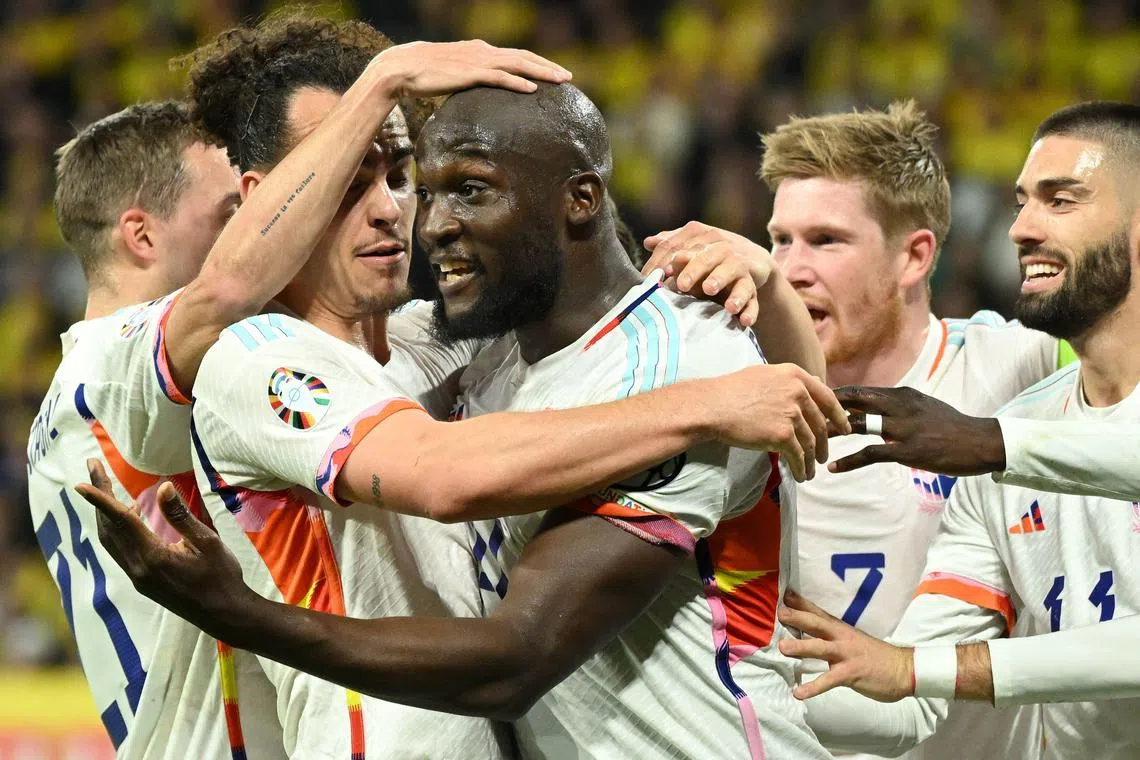 Belgian striker Romelu Lukaku (centre) celebrates scoring the opening goal with his teammates.