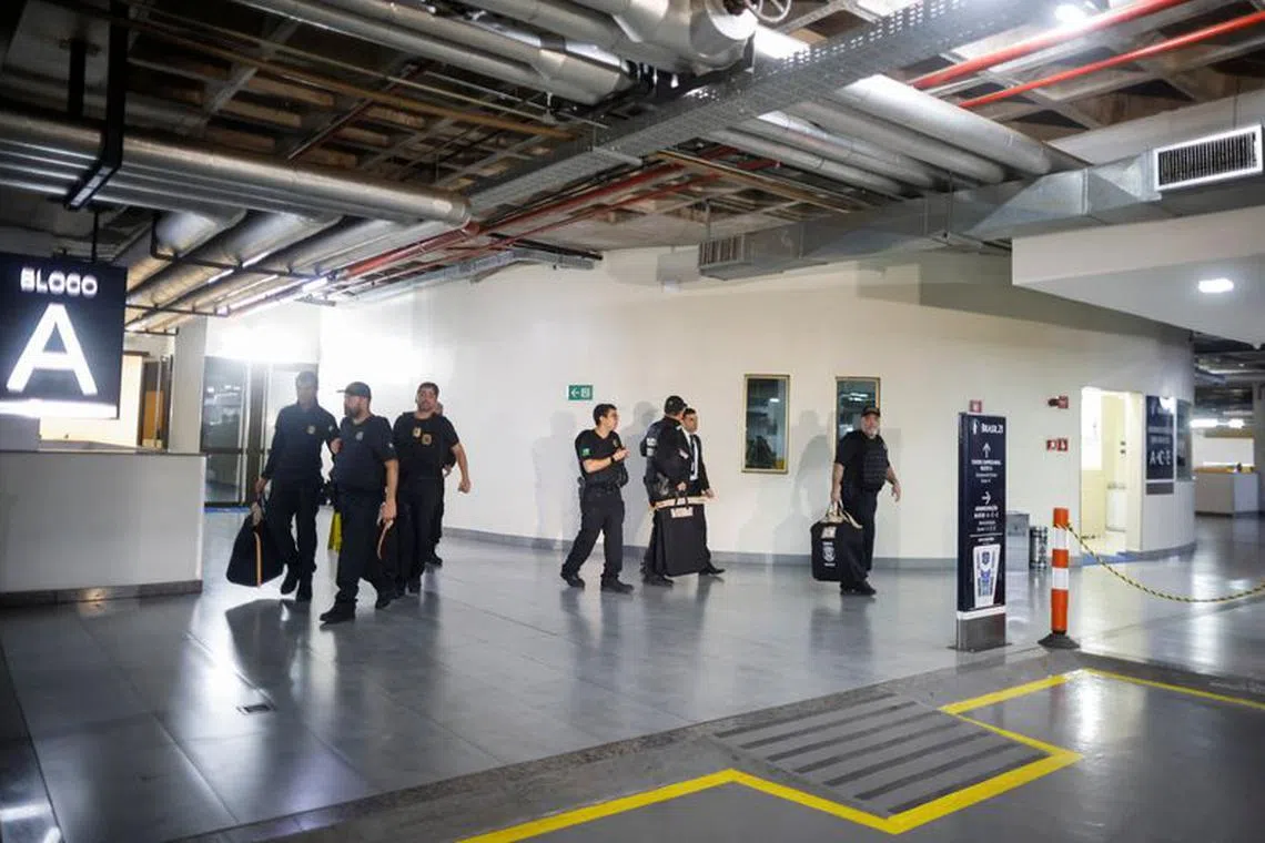 FILE PHOTO: Federal police officers leave the headquarters of the Liberal Party during an operation targeting some of former President Jair Bolsonaro's top aides in Brasilia, Brazil February 8, 2024. REUTERS/Adriano Machado