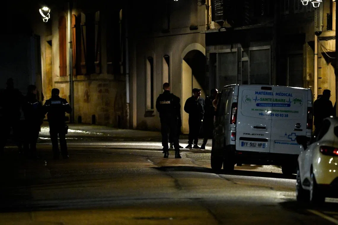 French gendarmes stand in front of the apartment where a five-year-old girl was found dead in a bag in Rambervillers, eastern France.