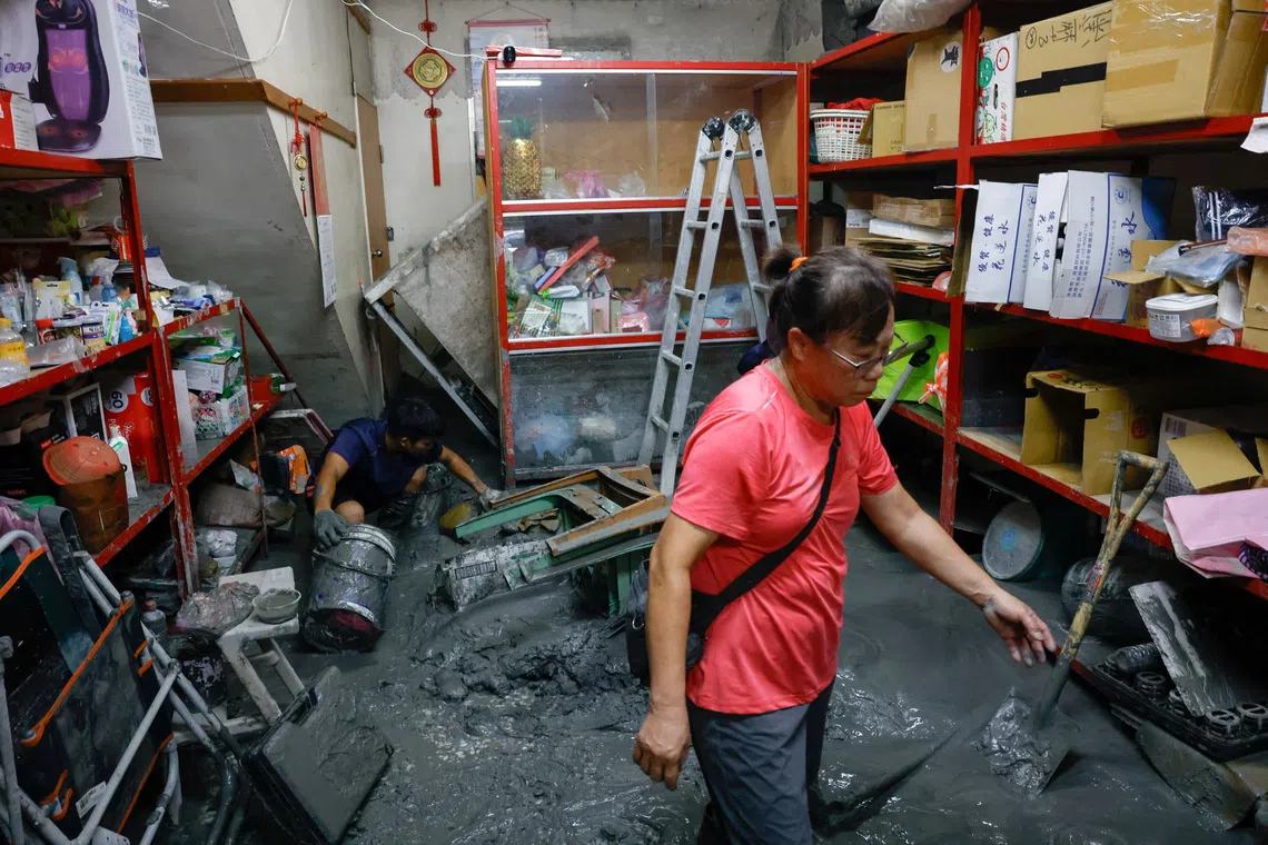 Residents clean up a shop covered in mud following flooding brought by Super Typhoon Ragasa in Hualien, Taiwan, September 26, 2025. REUTERS/Ann Wang