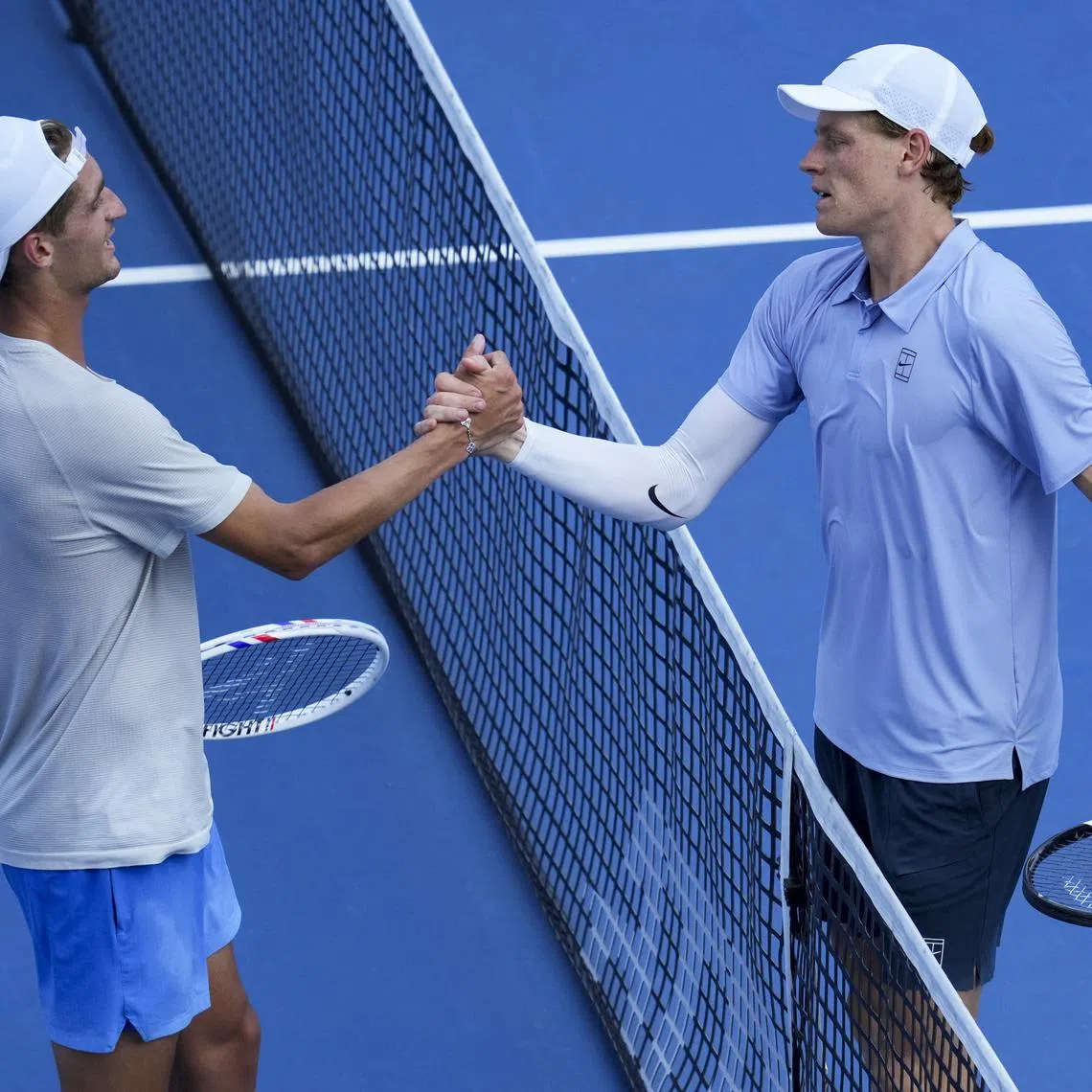 Aug 16, 2025; Cincinnati, OH, USA;  Jannik Sinner (ITA) right, meets Terence Atmane (FRA) at the net after their match during the Cincinnati Open at the Lindner Family Tennis Center. Mandatory Credit: Aaron Doster-Imagn Images