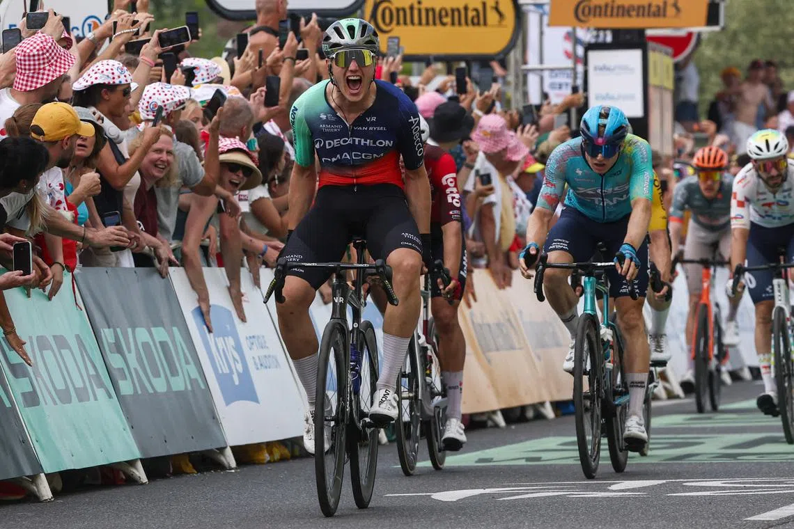 Decathlon CMA CGM Team’s Olav Kooij celebrates after crossing the line to win stage 5 of Tour de France ahead of XDS Astana Team’s Max Kanter and Soudal Quick-Step’s Tim Merlier on July 8.