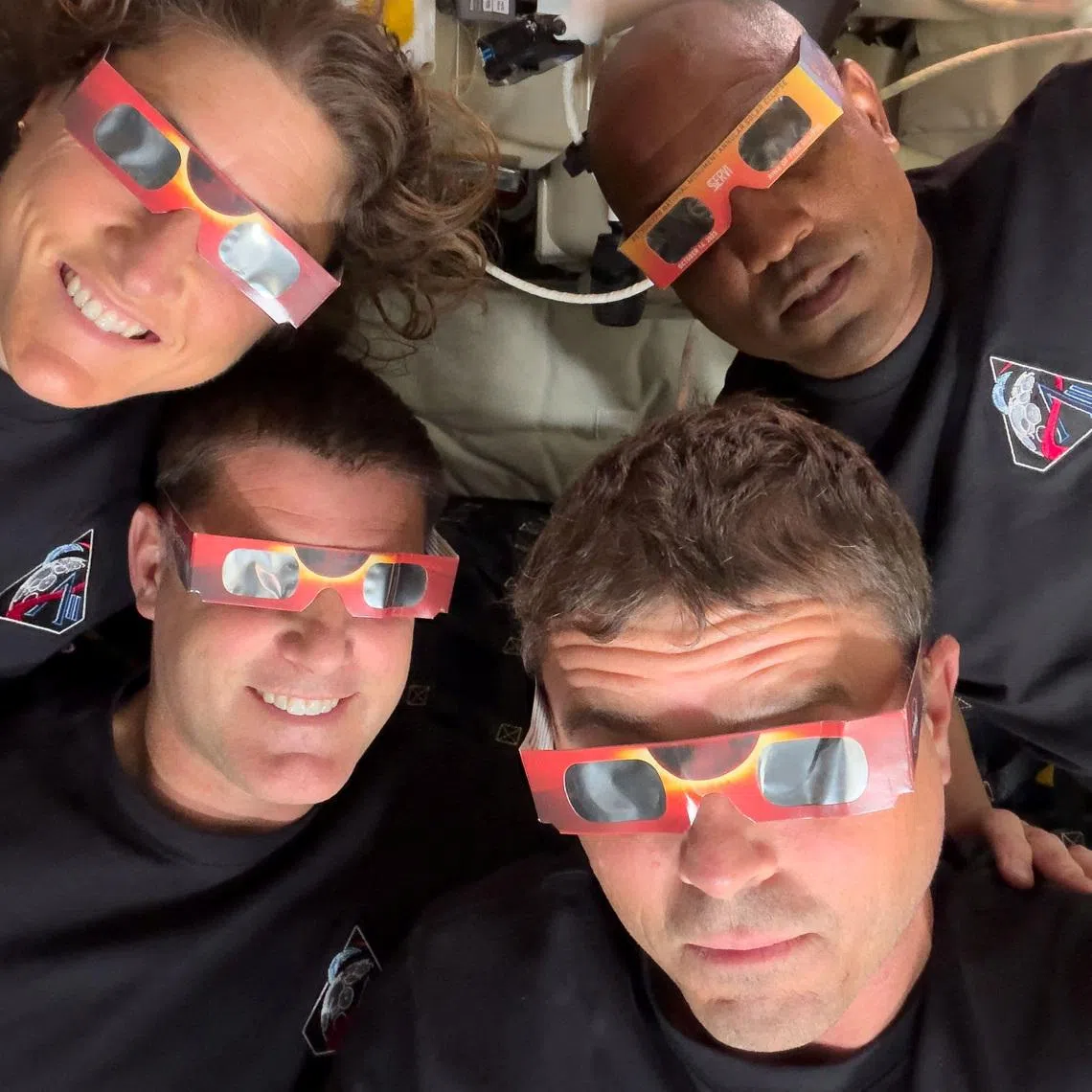 The Artemis II crew of NASA astronauts Christina Koch, Reid Wiseman, Victor Glover and Canadian Space Agency (CSA) astronaut Jeremy Hansen pose with their eclipse glasses used to protect their eyes for the Orion spacecraft's flyby of the Moon April 6, 2026.   Picture taken with a mobile phone.   NASA/Handout via REUTERS