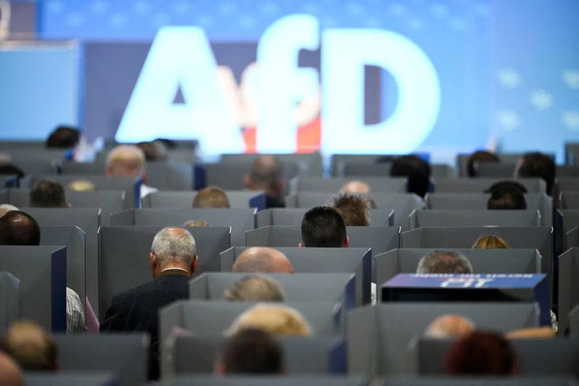 FILE PHOTO: AfD members sit in voting booths on the day of the European election assembly 2023 of the Alternative for Germany (AfD) in Magdeburg, Germany, July 29, 2023. REUTERS/Annegret Hilse/File Photo