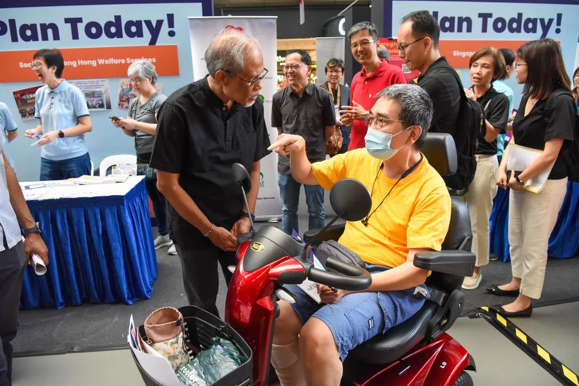 Minister for Social and Family Development Masagos Zulkifli (left) speaking to an applicant at the launch of the campaign on July 22.