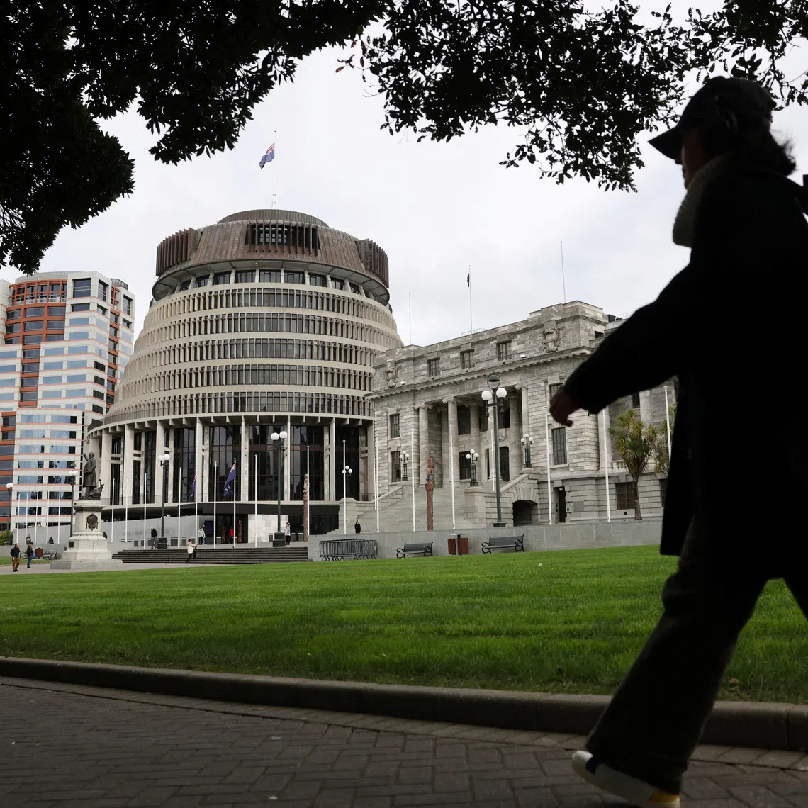 A woman walks near 'The Beehive', the executive wing of the New Zealand Parliament Buildings in Wellington, New Zealand, August 7, 2026. REUTERS/Hollie Adams