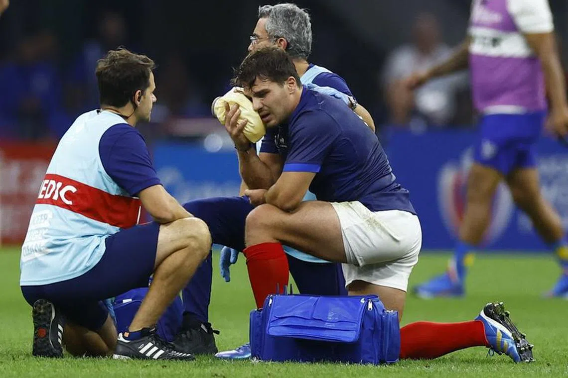 FILE PHOTO:Rugby Union - Rugby World Cup 2023 - Pool A - France v Namibia - Orange Velodrome, Marseille, France - September 21, 2023 France's Antoine Dupont receives medical attention after sustaining an injury REUTERS/Peter Cziborra/File Photo