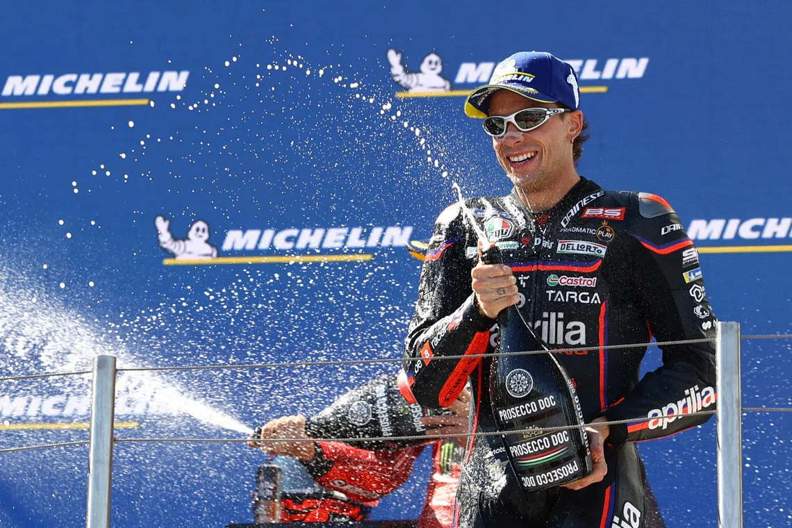 FILE PHOTO: MotoGP - Hungarian Grand Prix - Balaton Park Circuit, Balatonfokajart, Hungary - August 24, 2025 Aprilia Racing's Marco Bezzecchi celebrates on the podium after finishing third in the MotoGP race REUTERS/Bernadett Szabo/File Photo