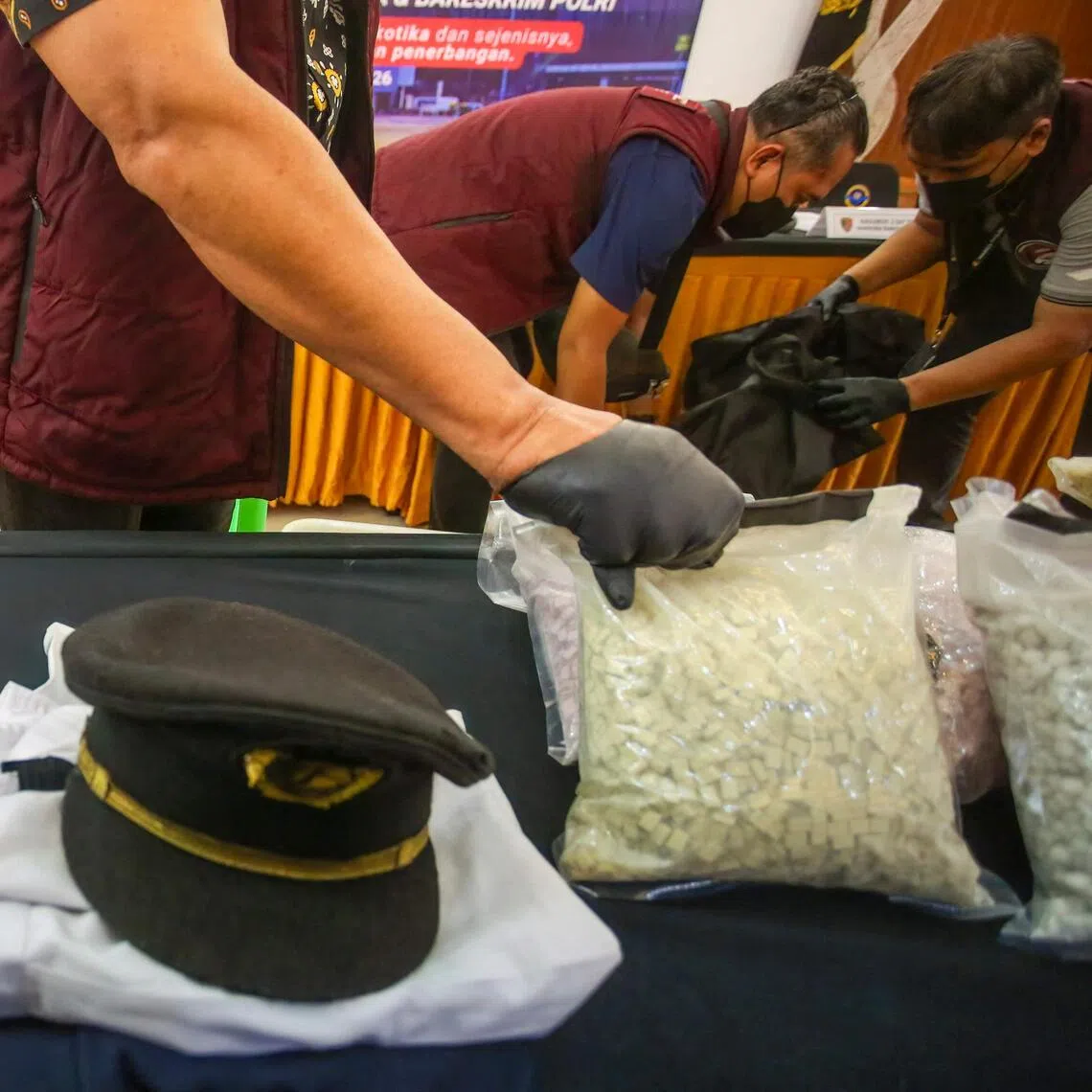 The uniform of a Malaysian pilot and drugs he smuggled at a press conference at Soekarno-Hatta International Airport near Jakarta on July 31.