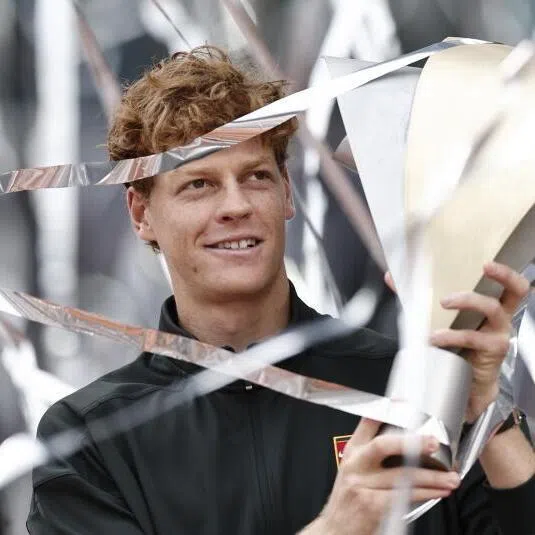 Jannik Sinner celebrates with the trophy after winning the men's singles finals match against Alexander Zverev at the Madrid Open on May 3.