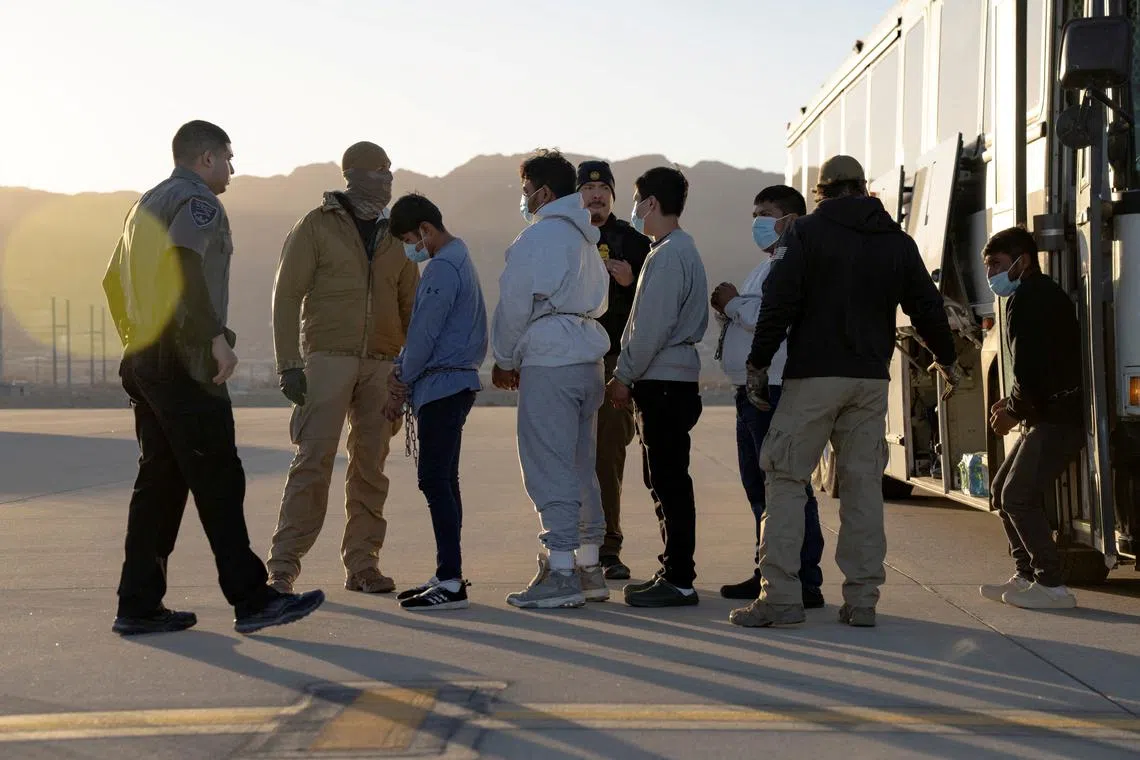 FILE PHOTO: U.S. Customs and Border Protection security agents guide detained migrants to board a U.S. Air Force C-17 Globemaster III aircraft for a removal flight at Fort Bliss, Texas, U.S.  January 23, 2025.  Dept. of Defense/U.S. Army Sgt. 1st Class Nicholas J. De La Pena/Handout via REUTERS/File Photo