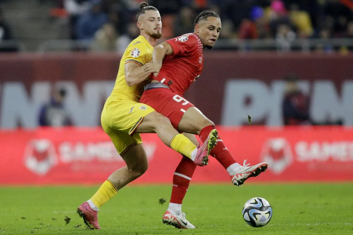 FILE PHOTO: Soccer Football - UEFA Euro 2024 qualifier - Group I - Romania v Switzerland - National Arena, Bucharest, Romania - November 21, 2023  Romania's Radu Dragusin in action with Switzerland's Noah Okafor Inquam Photos via REUTERS/Octav Ganea/File Photo