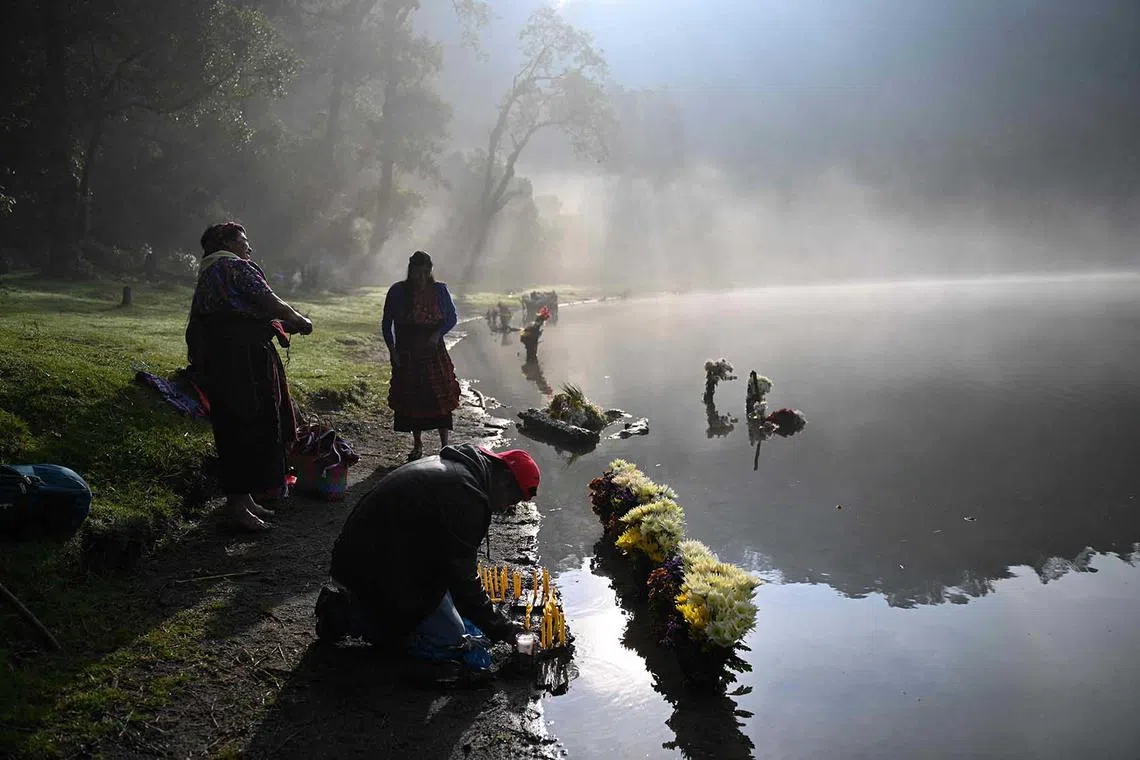 Indigenous people take part in the 'Prayer for Rain' ceremony on the shore of Chicabal Lagoon, formed in the crater of an extinct volcano and considered by Mayan people as a sacred place, in San Martin Sacatepequez, Guatemala, on May 18. The ceremony is performed to bless the crops. 