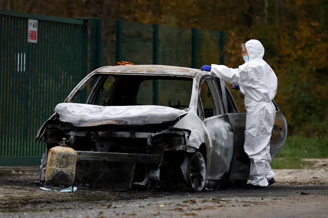 A French gendarme inspects the burnt car used by a driver who rammed into pedestrians and cyclists near Saint-Pierre-d'Oleron on the touristic French island of Ile d'Oleron, off the Atlantic coast, France, November 5, 2025. REUTERS/Stephane Mahe