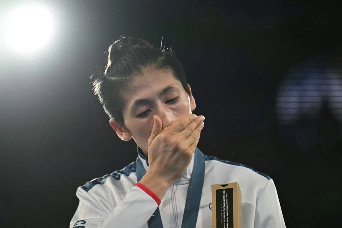 Gold medallist Taiwan's Lin Yu-ting celebrating on the podium during the medal ceremony for the women's 57kg final boxing category during the Paris 2024 Olympic Games at Roland Garros on Aug 10.