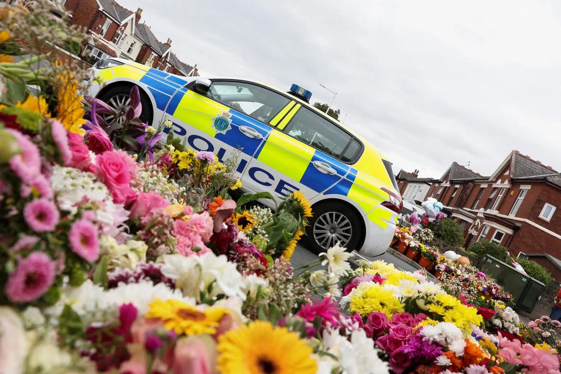 FILE PHOTO: A police car sits parked near the floral tributes in memory of Elsie Dot Stancombe, Bebe King and Alice Dasilva Aguiar, three children victims of a knife attack during a dance event in Southport, Britain August 5, 2024. REUTERS/Manon Cruz/File Photo