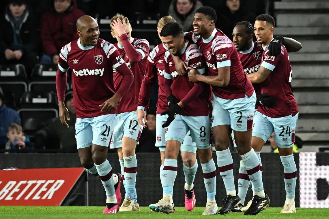 Midfielder Michail Antonio (second from right) celebrates scoring West Ham's second goal with teammates.