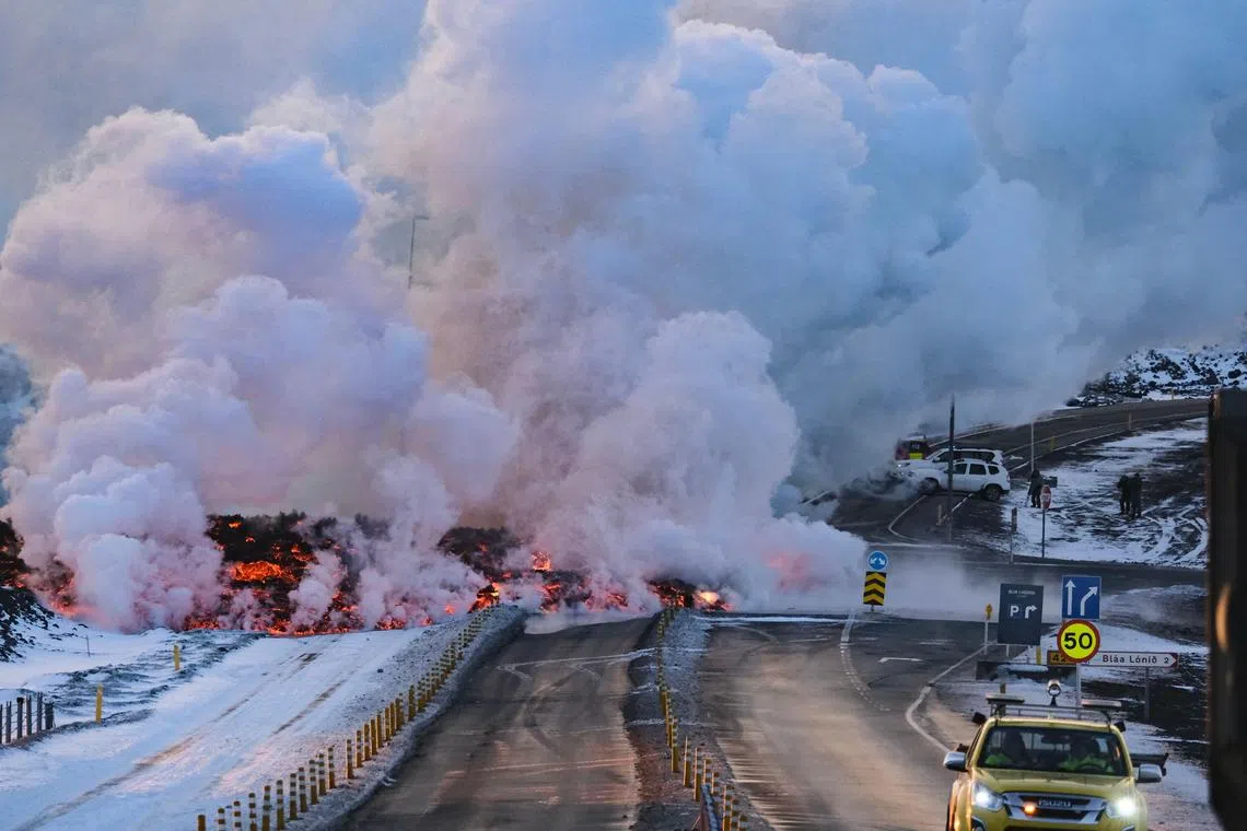 Molten lava is seen overflowing on the road leading to the famous tourist destination Blue Lagoon, a luxury geothermal spa, near Grindavik, western Iceland, on Feb 8, 2023. 