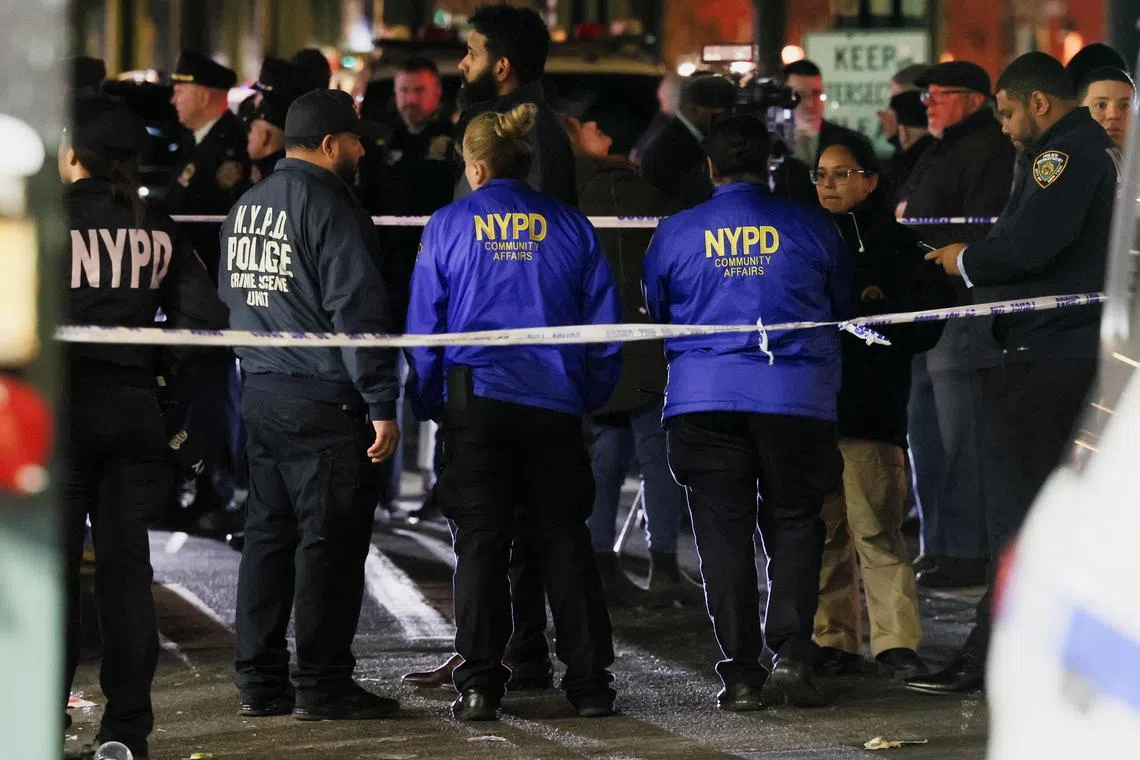 Members of the New York Police Department investigate the scene of a shooting at a subway station in the Bronx.