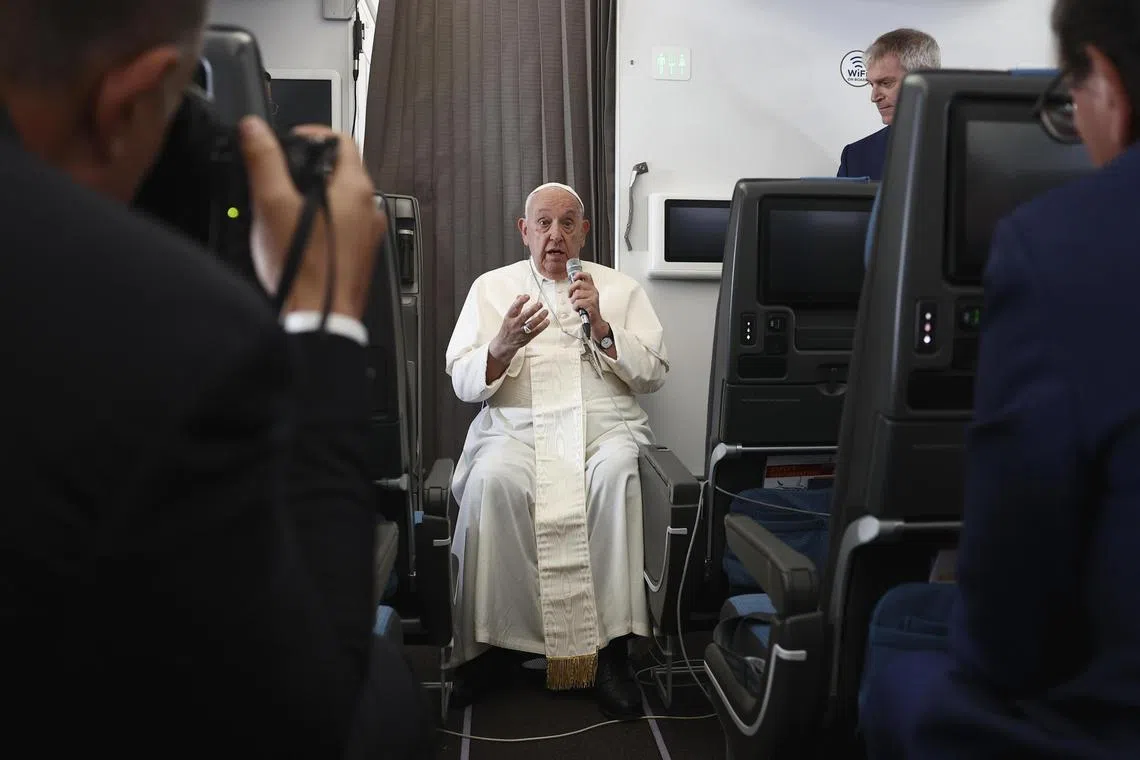 Pope Francis speaking during a news conference aboard the papal plane on his flight back after his 12-day journey across Asia. 