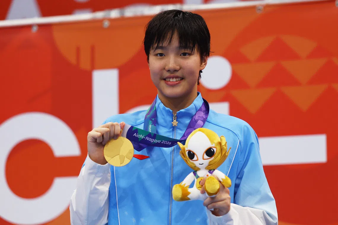 Asian Games - Aichi-Nagoya 2026 - Swimming - Tokyo Aquatics Centre, Koto, Tokyo, Japan - September 23, 2026 Gold medallist China's Zidi Yu celebrates on the podium after winning the Women's 400m Individual Medley Final REUTERS/Manami Yamada
