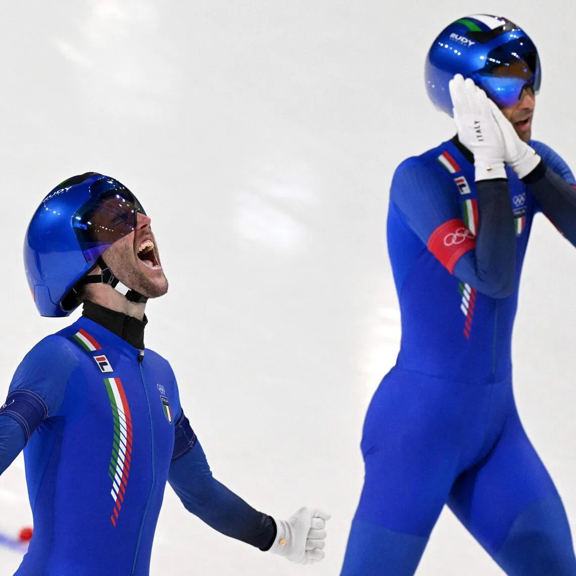 Italy's Michele Malfatti (left) and Andrea Giovannini celebrate after winning gold in the speed skating men's team pursuit final on Feb 17.