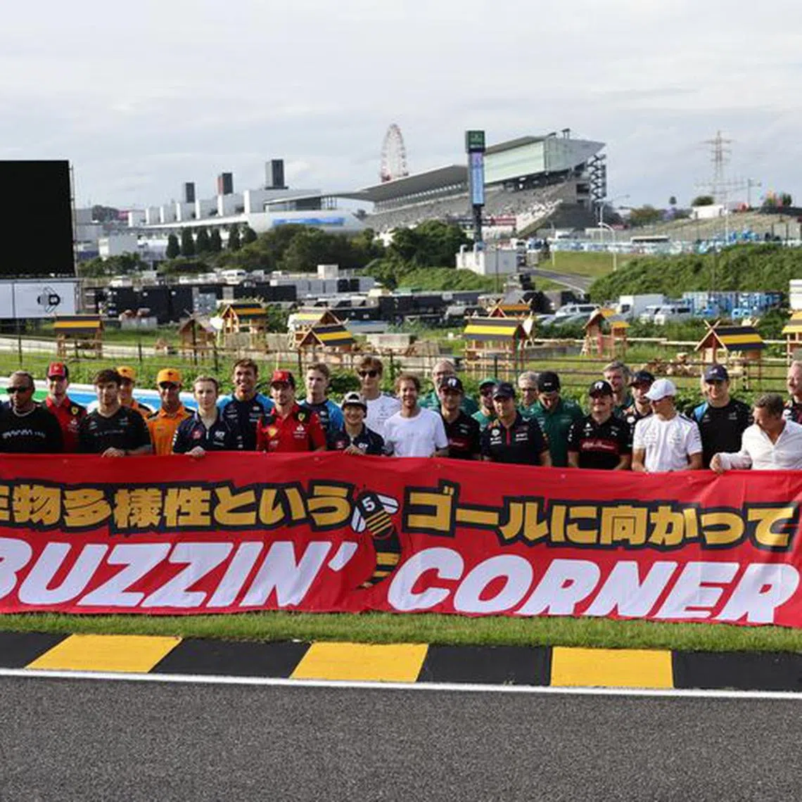 Formula One F1 - Japanese Grand Prix - Suzuka Circuit, Suzuka, Japan - September 21, 2023 Former driver Sebastian Vettel poses with drivers and team members as he launches 'Buzzin' Corner' a project to raise awareness about the importance of biodiversity REUTERS/Issei Kato