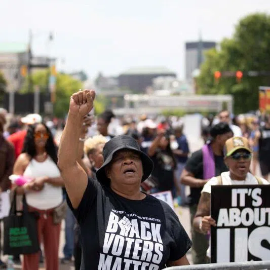 People march at a rally against US redistricting efforts, outside the state capitol building in Montgomery, Alabama, on May 16, 2026.