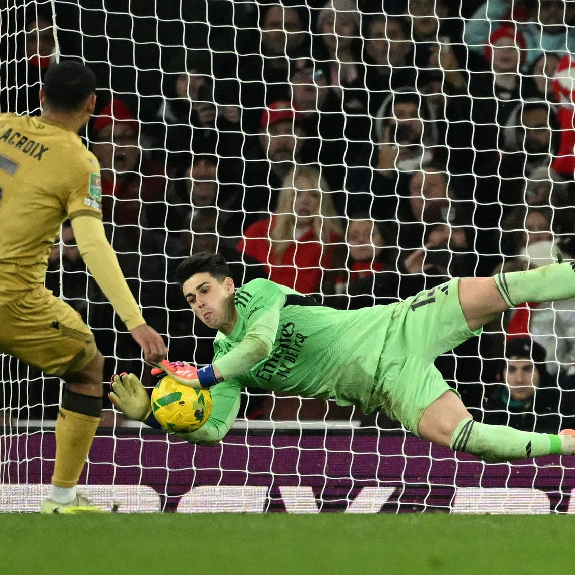 Soccer Football - Carabao Cup - Quarter Final - Arsenal v Crystal Palace - Emirates Stadium, London, Britain - December 23, 2025 Arsenal's Kepa Arrizabalaga saves a penalty from Crystal Palace's Maxence Lacroix during the penalty shootout REUTERS/Dylan Martinez