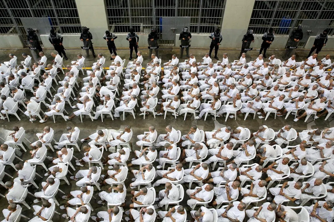 In El Salvador, shackled prisoners watch their mass trial on a big screen